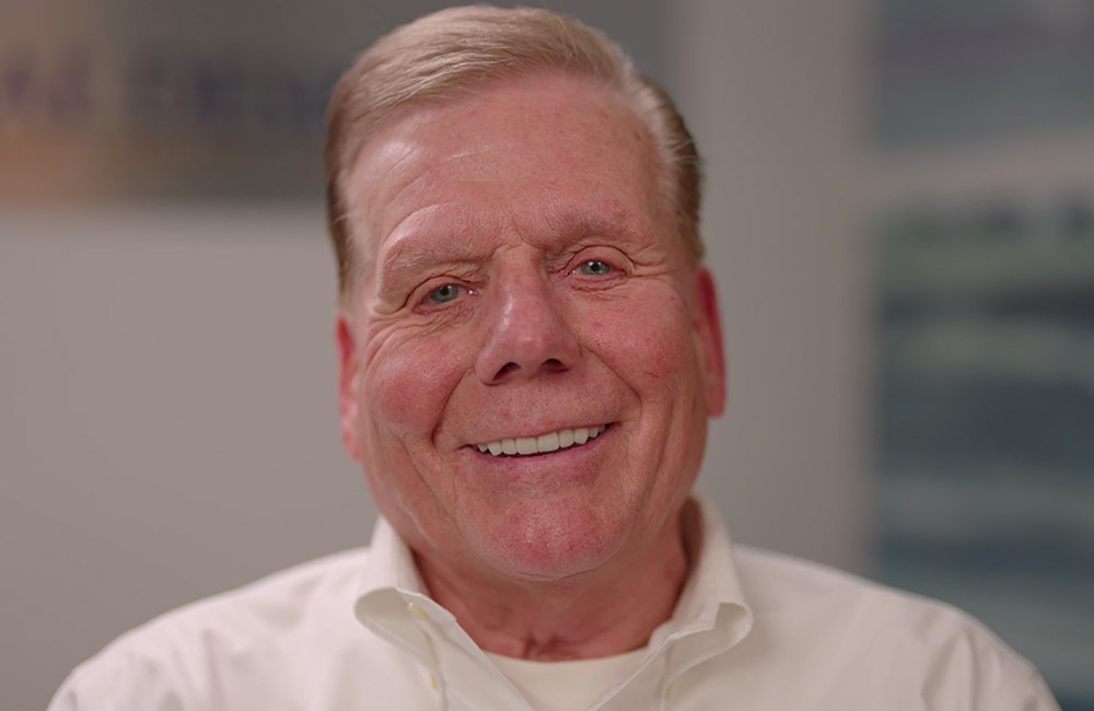 headshot of Eddie smiling after a all-on-x procedure.