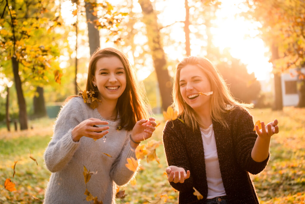 Friends having fun smiling in the fall