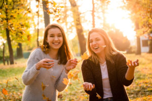 Friends having fun smiling in the fall