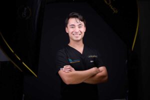 zane clark gold headshot black scrubs