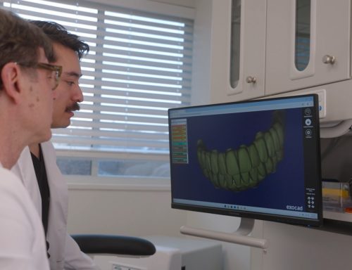 dr van and dr clark gold looking at a full arch rendering