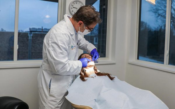 Dr. Van checking on a patients dental implants