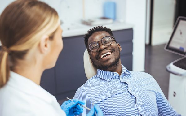 smiling patient after a full arch dental implant procedure