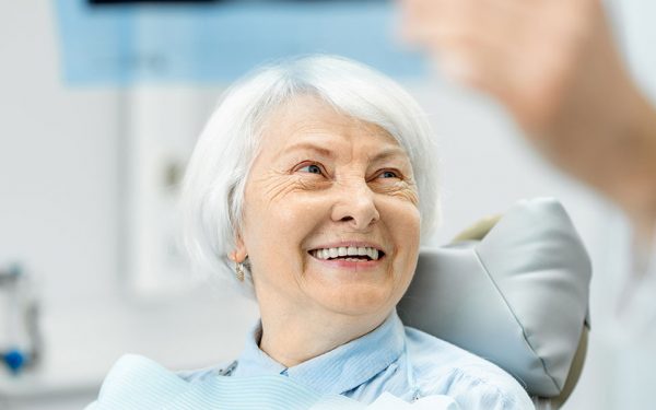 patient sitting in a dental chair smiling